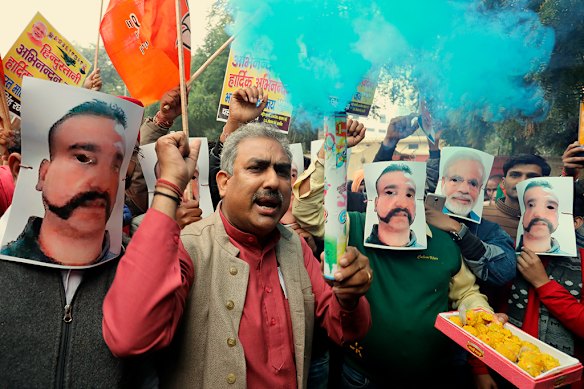 In New Delhi, people celebrated the release of fighter pilot Abhinandan Varthaman by wearing images of his face, with one person also wearing Indian leader Narendra Modi’s face (second from right) in 2019.