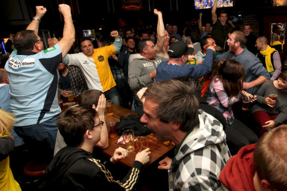 Socceroos fans rejoice at Cheers Bar in 2014 as Australia scores against Holland in the World Cup in Brazil.