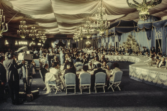 Guests enjoy champagne and foie gras in the banquet tent at the Shah’s 1971 party.