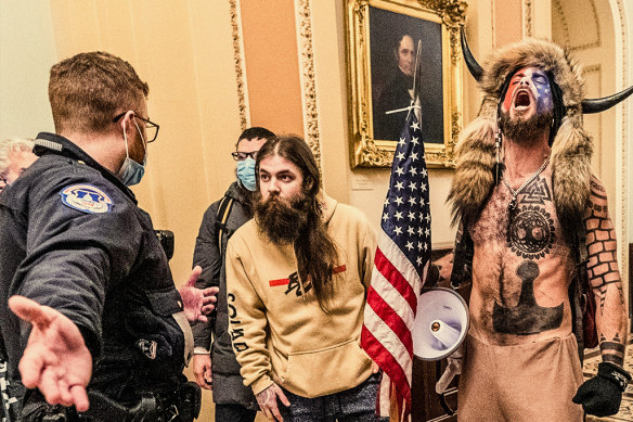 Jacob Chansley (right) yells as a fellow rioter confronts Capitol police in Washington DC on January 6, 2021.