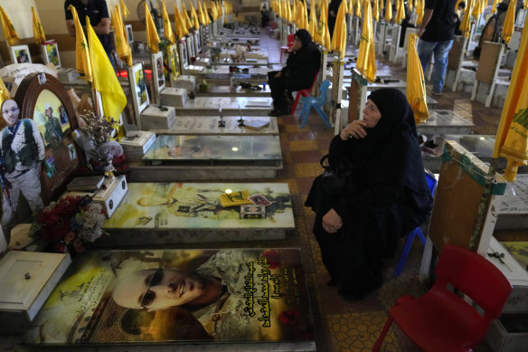 Women visit the graves of killed Hezbollah members in the southern suburbs of Beirut.