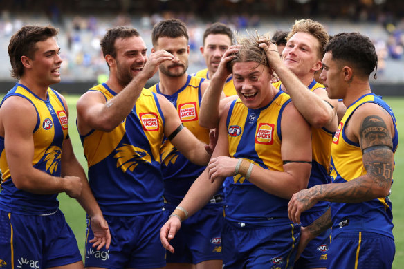 Teammates surround Harley Reid after their win against Richmond at Optus Stadium. 