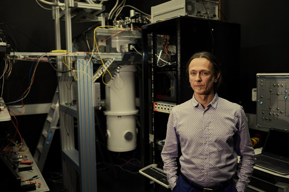 Andrea Morello in front of a refrigerator that cools his quantum computer chip to minus 273.05 degrees.