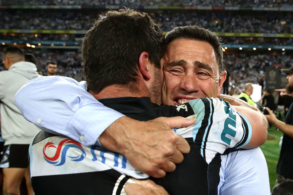 Ennis and Flanagan embrace after the Sharks won the 2016 grand final against Melbourne.