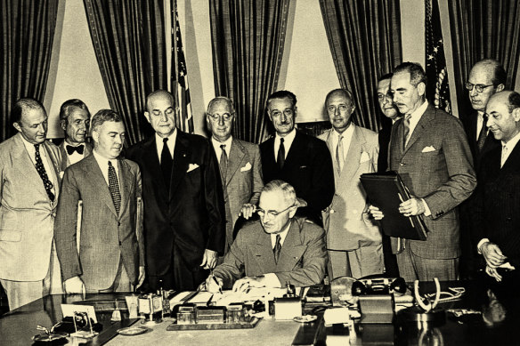 US president Harry Truman signs the North Atlantic Pact creating the North Atlantic Treaty Organisation as foreign diplomats watch, on August 24, 1949. 