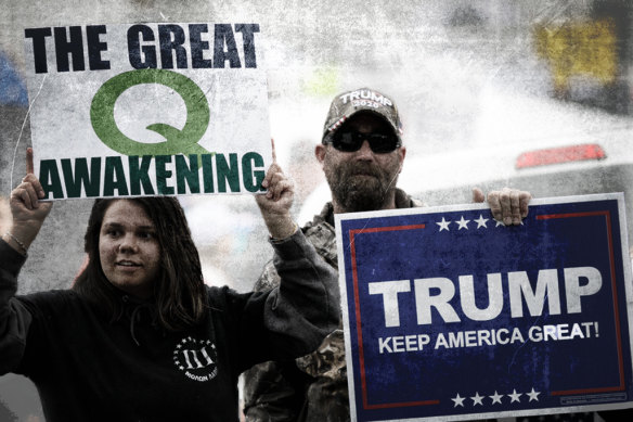 A QAnon supporter holds a sign during a May protest against statewide closures to contain the coronavirus in Oregon, United States.