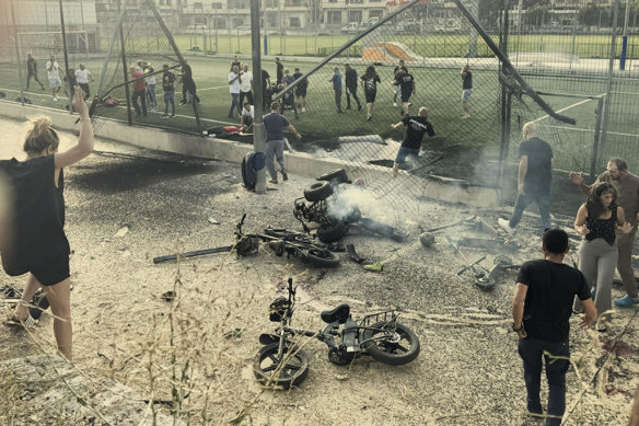 Residents of the town Majdal Shams, in the Golan Heights, rush to help injured children moments after a rocket fired from Lebanon hit a soccer field. 