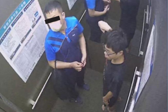 Hsia (left) and “Little” Lai inside an apartment building lift on the morning Lai was found dead outside the building. 