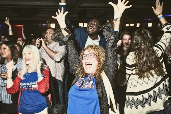 Democrat supporters celebrate during the 2018 midterms after projections showed their party had gained control of the House of Representatives.