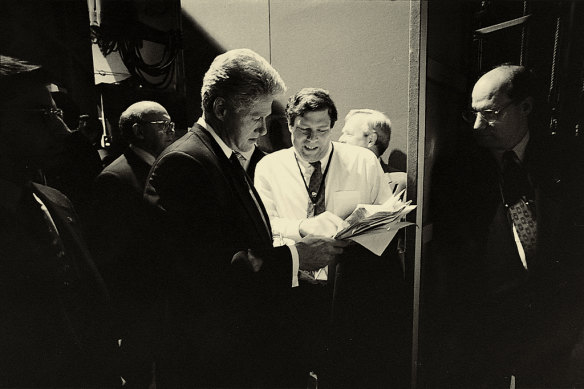 Bill Clinton is shown survey numbers by his pollster as he prepares for a presidential debate in October 1996.