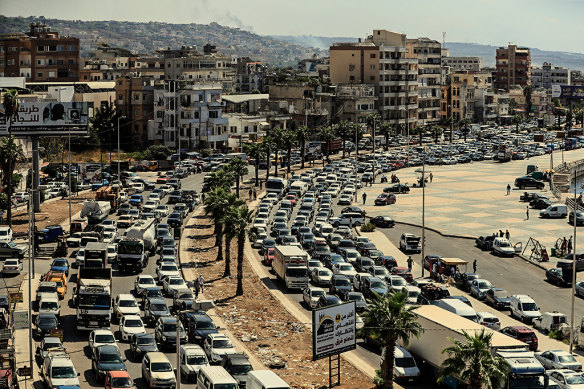 Lebanese families sit in a traffic jam as they flee southern villages amid Israeli airstrikes.