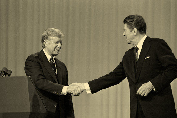 President Jimmy Carter shakes hands with Ronald Reagan before they debate in 1980. Polls said the result was too close to call. Reagan won by a landslide.