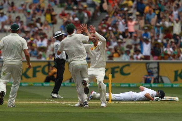 Mitchell Johnson celebrates with Nathan Lyon after Johnson threw down the stumps to run out Joe Root at the MCG in 2013.