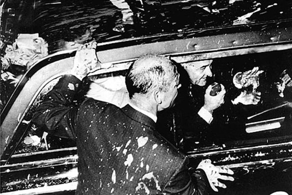 President Lyndon Johnson drives through the streets of Melbourne after his car was splattered with paint. 