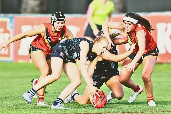 Maddy Meagher, front, swoops in during a match between Victoria Metro and South Australia in the AFL national championships under-18s in Adelaide in June. 