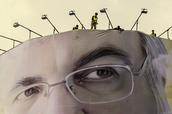 In Iran’s capital, Tehran, workers install a huge portrait of Hezbollah leader Hassan Nasrallah who was killed in an Israeli airstrike in Lebanon on September 27.