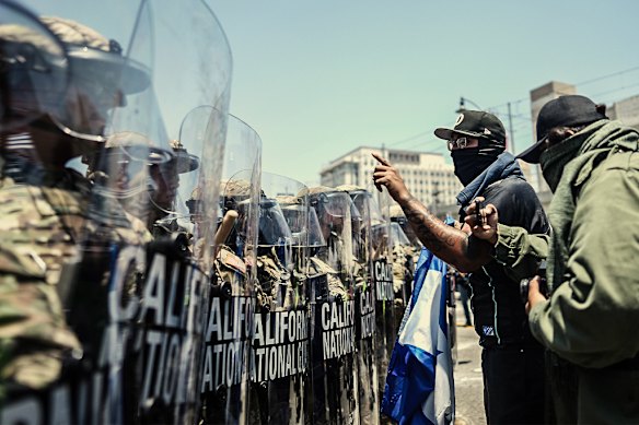 Protesters confront California National guardsmen in downtown LA on Sunday (LA time).