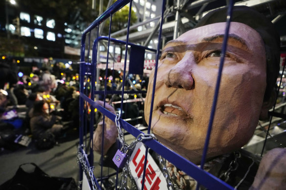 A caricature depicting an imprisoned  Yoon Suk Yeol is displayed during a rally   outside the National Assembly in Seoul on December 13.