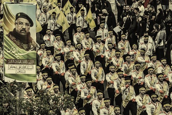 Hezbollah fighters and mourners at the funeral of commander Fuad Shukr, who died in a missile strike on Beirut on July 30.