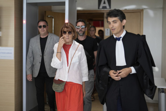 Gisele Pelicot leaves an earlier court hearing in Avignon with her sons, David (left), Florian (background) and her lawyer Stephane Babonneau (right).