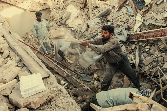 Iranian men clear rubble after a quake devastated the UNESCO-heritage-listed city of Bam in 2003. 