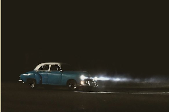 A car drives during a power outage in Havana on February 15, 2025. Blackouts were a feature of life but have become more frequent since oil was blocked to the island. 