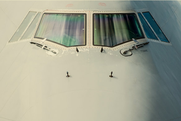 The cockpit front windows of a 747 jet.