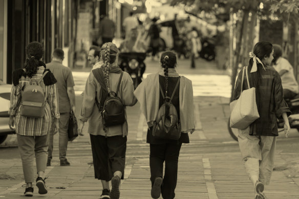 Young women on an avenue in downtown Tehran in September 2023.