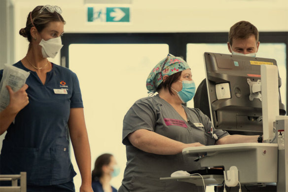 Critical nurse Catherine Bell (centre) monitors patients as they emerge from coma at The Alfred intensive care unit in Melbourne. 