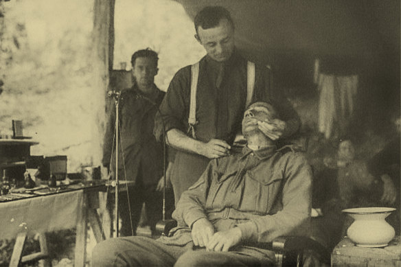 A soldier has his teeth attended to by a dental unit attached to his artillery division in France in 1918. 