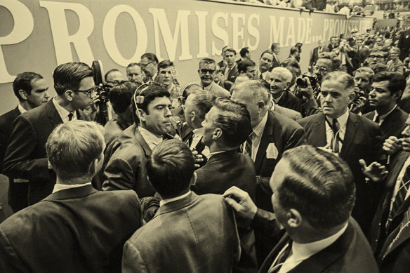 Reporter Dan Rather is surrounded by security guards after he tried to question someone being escorted out of the famously volatile Democratic National Convention of 1968 in Chicago.