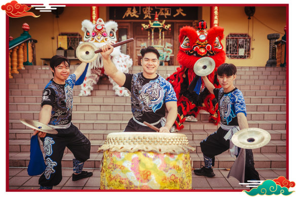 Kelvin Tran (centre) with team members Brendan Au-Dang and William Ly and lion dancers at the Mingyue Lay Buddhist Temple in Sydney.