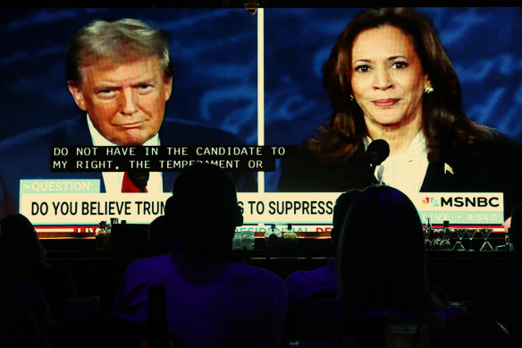 Bar patrons in California watch Donald Trump and Kamala Harris in a TV election debate in September.