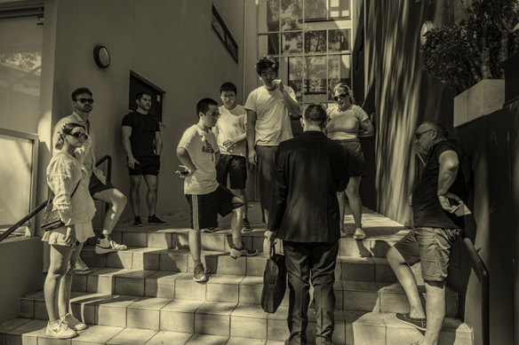 A group of prospective renters wait to view a property in Sydney.