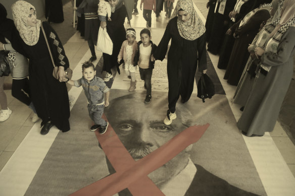 Palestinians walk over an image of former British prime minister Arthur Balfour during a protest in Gaza City in 2022. 