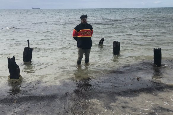 Gunditjmara man Chris Saunders and the remnants of a whalers’ jetty at The Convincing Ground, where an unknown number of Aboriginal people were massacred in the early 1830s.