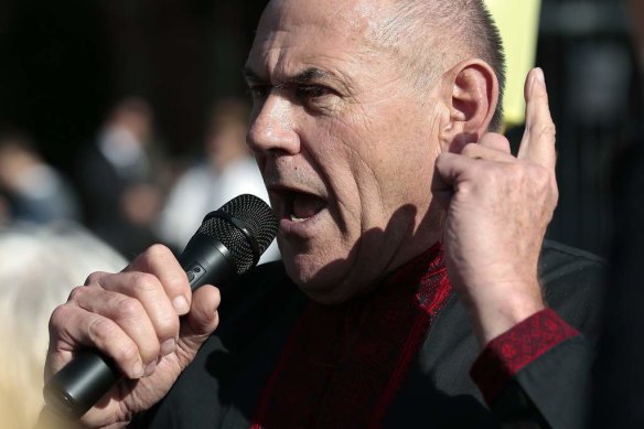 Australian Federation of Ukrainian Organisations chairman Stefan Romaniw speaks at a recent rally. 