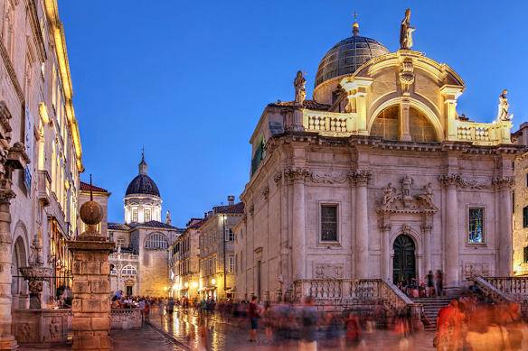 Nightfall in the old city of Dubrovnik, the cathedral dome and the Saint Blaise Church is a timeless silhouette in Croatia's coastal jewels.