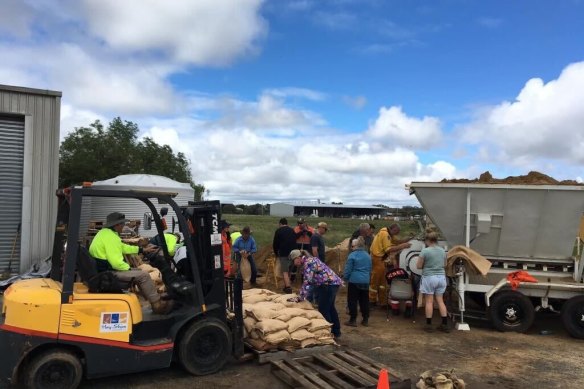 Locals fill sandbags in Hay on Tuesday morning, in an effort to keep the rising Murrumbidgee River out of their town.