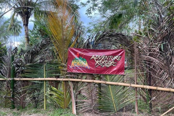 A blockade of the Kokoda Track with an Adventure Kokoda sign.