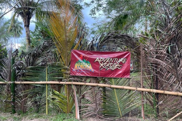 A blockage of the Kokoda Track with an Adventure Kokoda sign.