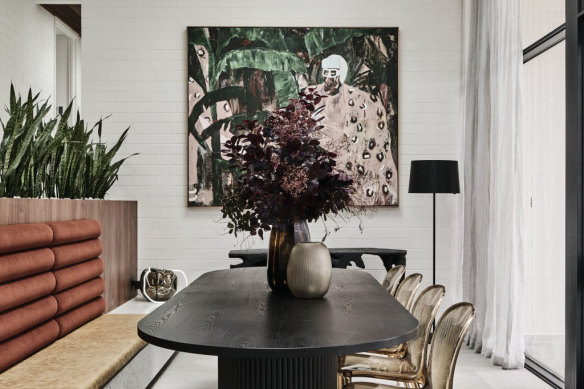 The dining room is fitted with a terrazzo bench featuring a leather cushioned seat and an alpaca velvet backrest. 