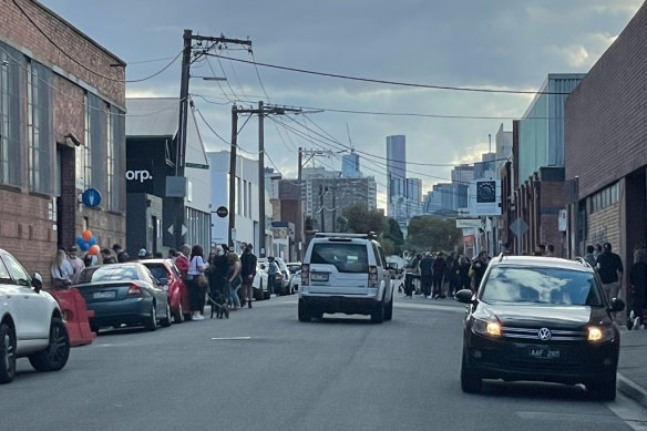 An event in August with people gathered on the street.