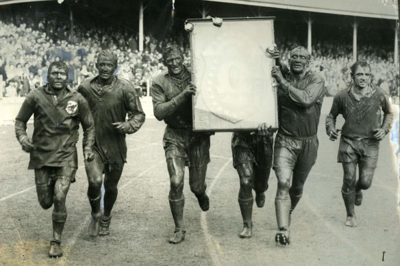 Captain Norm Provan and second-rower Kevin Ryan carry the J.J Giltinan Shield during St George's victory lap at the SCG in 1963.