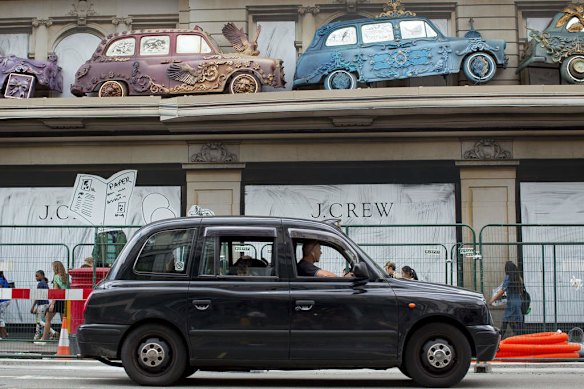 A black London taxi cab in the streets of London.
