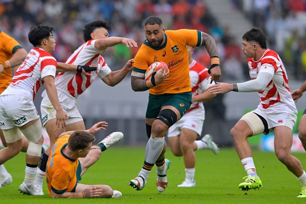 Lukhan Salakaia-Loto of Australia runs with the ball.