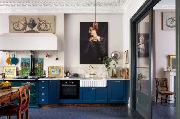 An open plan kitchen with blue cabinets