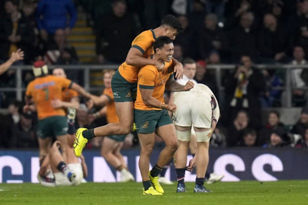 Australia's Len Ikitau (right) and Joseph Suaalii celebrate after teammate Max Jorgensen (not pictured) scored. 