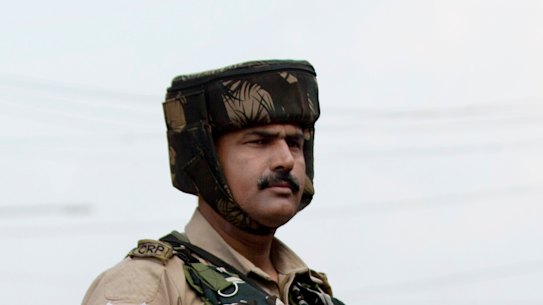 Indian paramilitary soldiers stand guard during curfew in Srinagar on August 7.