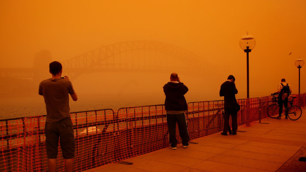 Tourists and locals gathered at Circular Quay to take photographs of the Sydney Harbour Bridge during the 2009 dust storm.